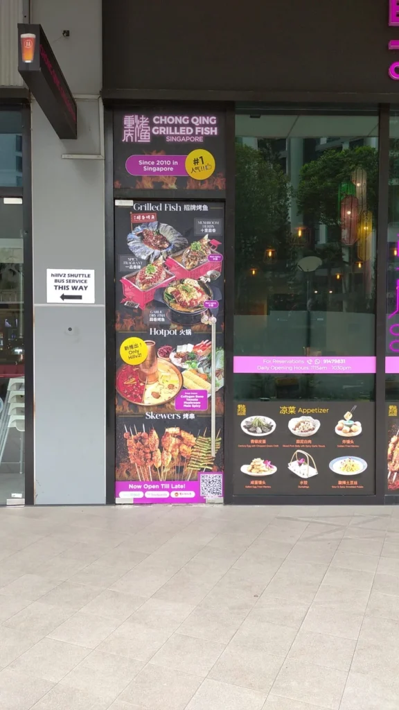 Full-height storefront window display using large format printing to showcase vibrant food photos and branding for Chong Qing Grilled Fish