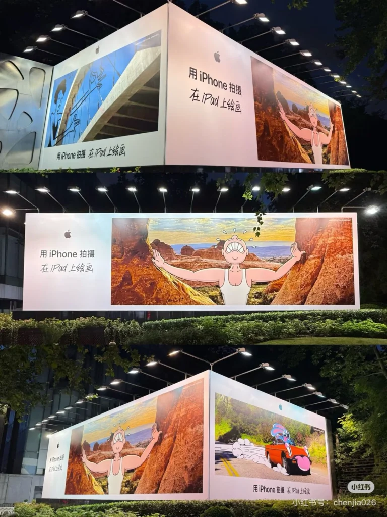 Massive illuminated outdoor corner billboard displaying high-contrast creative artwork in Singapore at night
