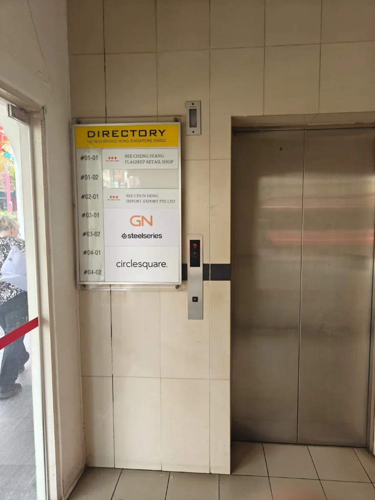 A directory signage listing the unit numbers and store names.