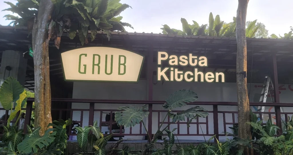 An illuminated outdoor storefront sign and 3D lettering for Grub Pasta Kitchen