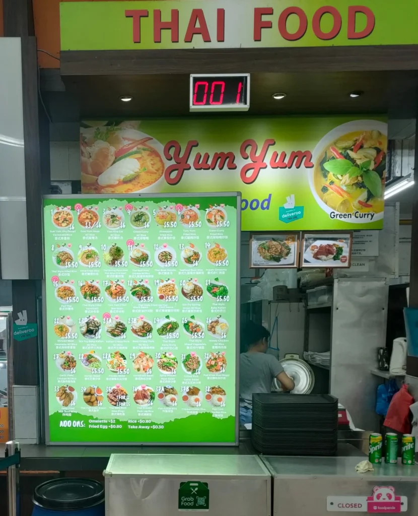 A illuminated menu boards displaying photos and prices of the dishes.